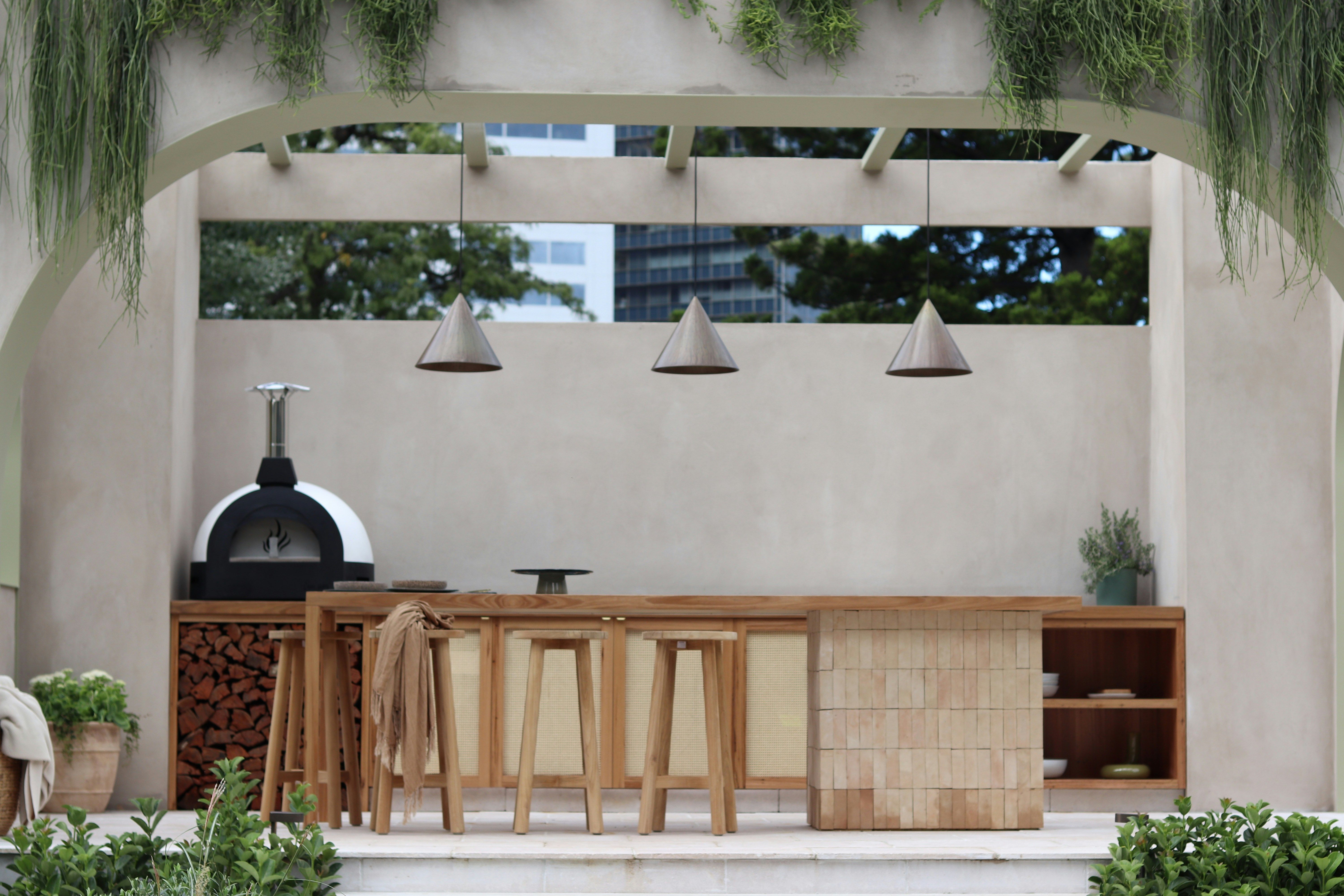 Design a compact outdoor kitchen using reclaimed wood and natural materials for cozy and sustainable fall patio ideas.