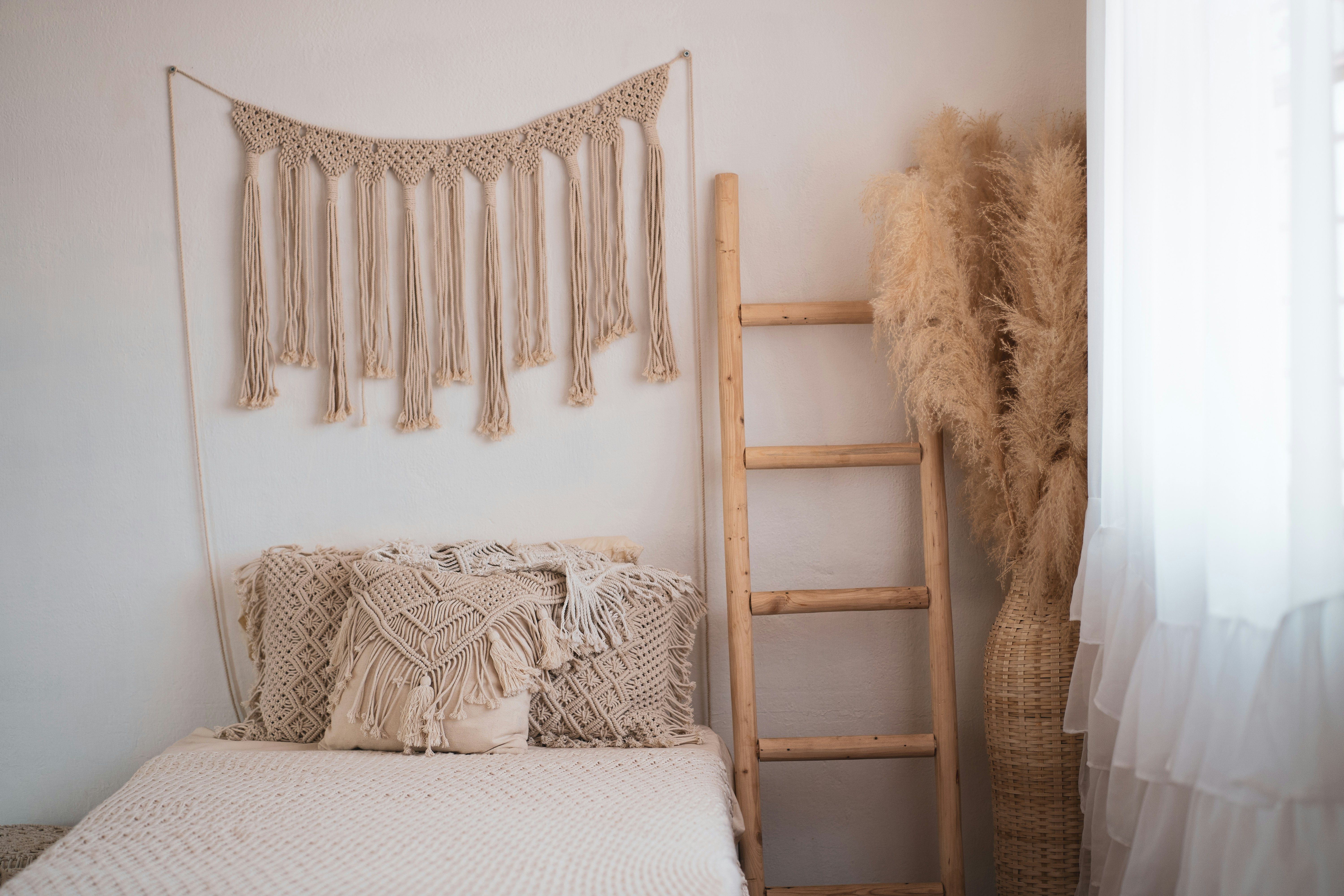 Bedroom with sheer curtain panels allowing sunlight to enhance biophilic interior design