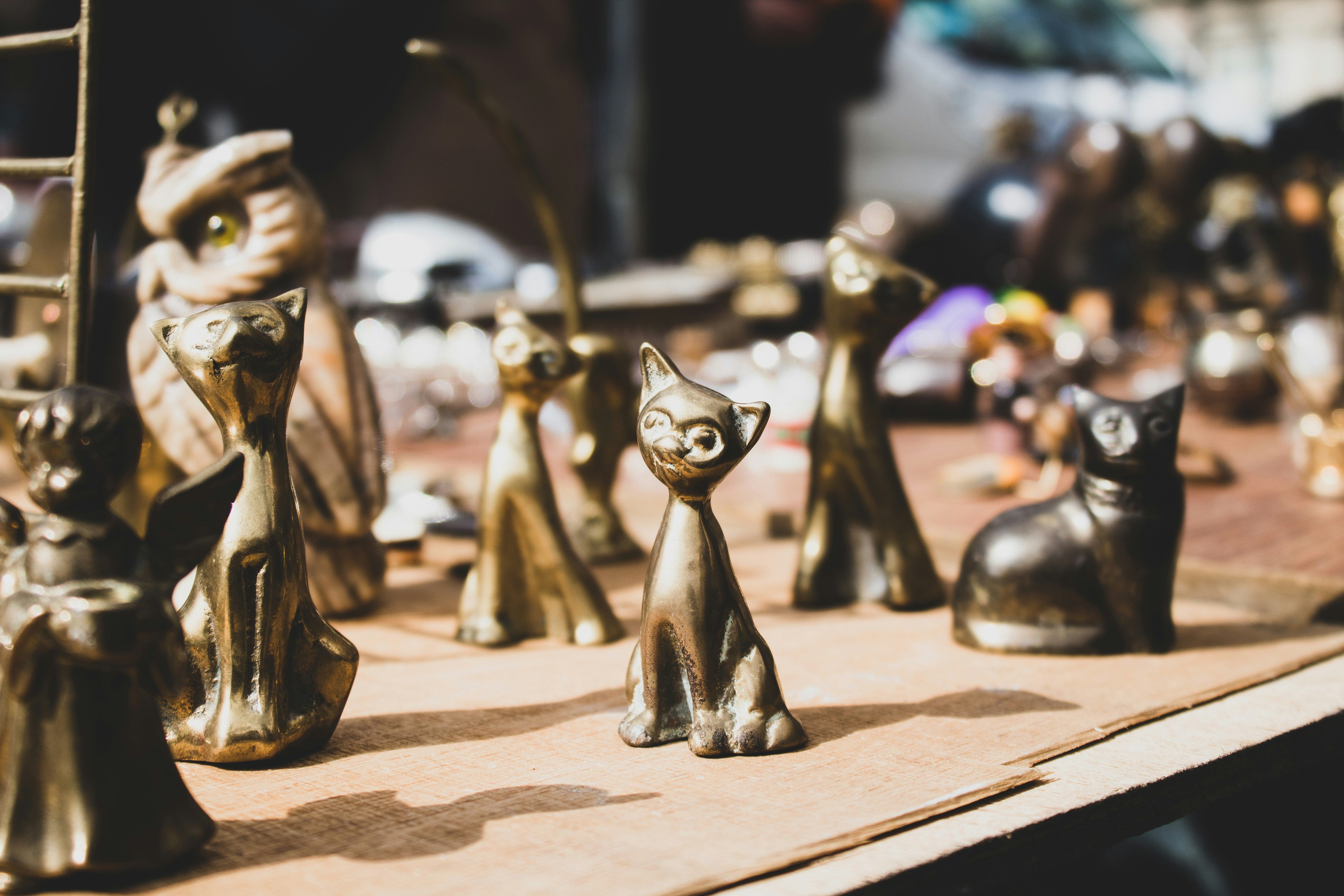 Layered heirloom fall decor with brass candlesticks, pumpkins, and vintage books