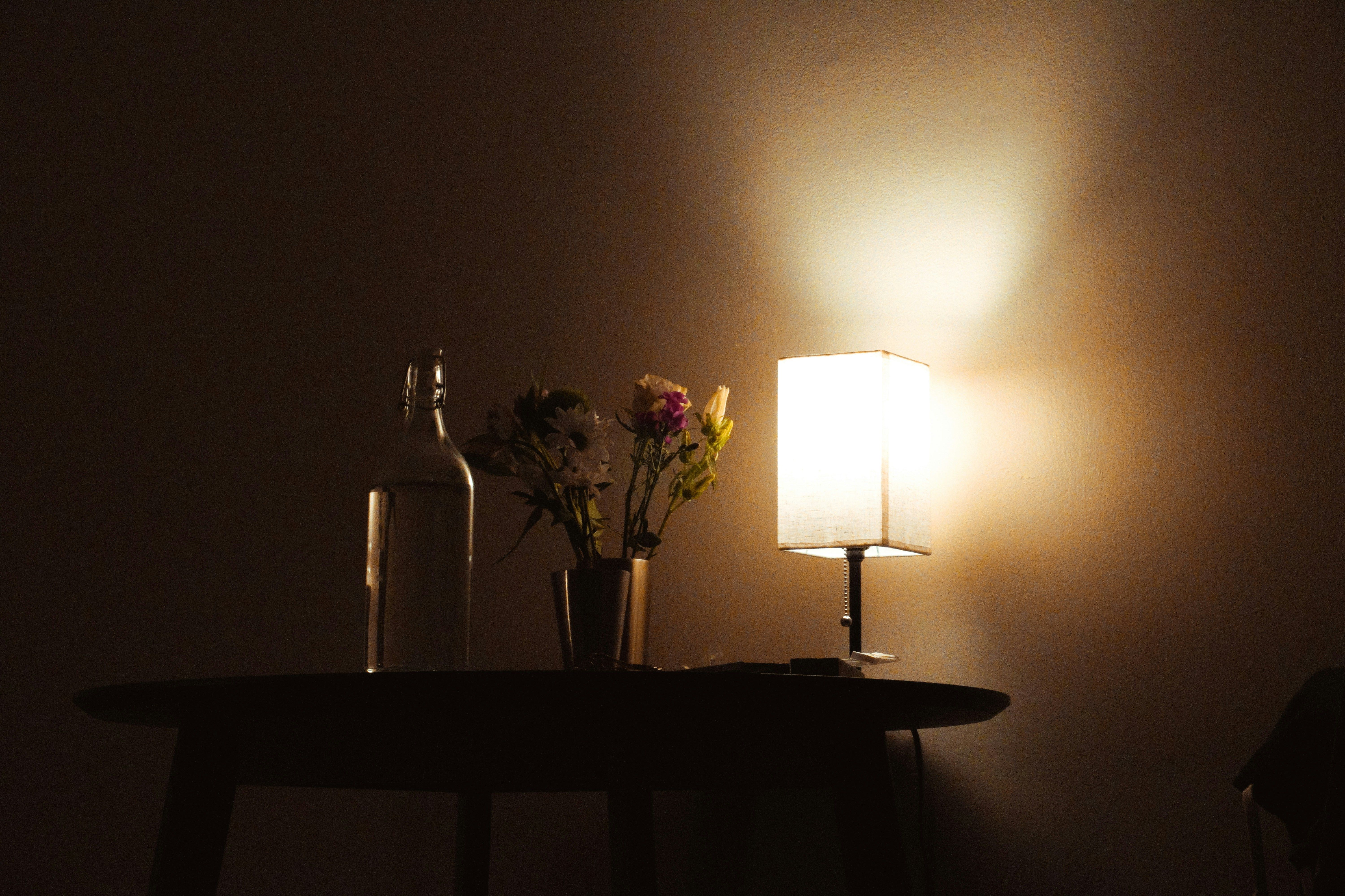 Layered fall lighting with table lamps and sconces creating a warm grandmillennial glow